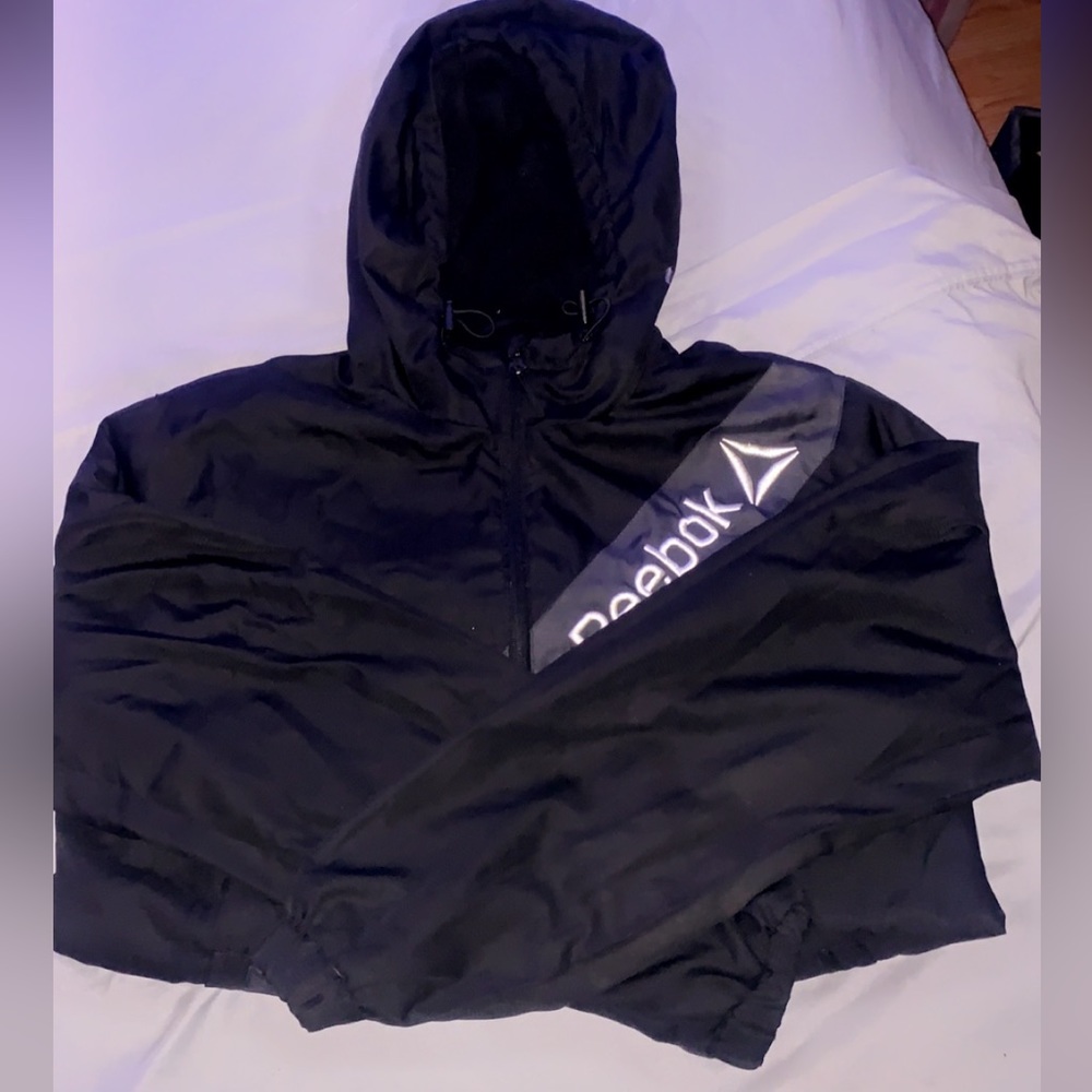 Black Reebok zip-up raincoat.